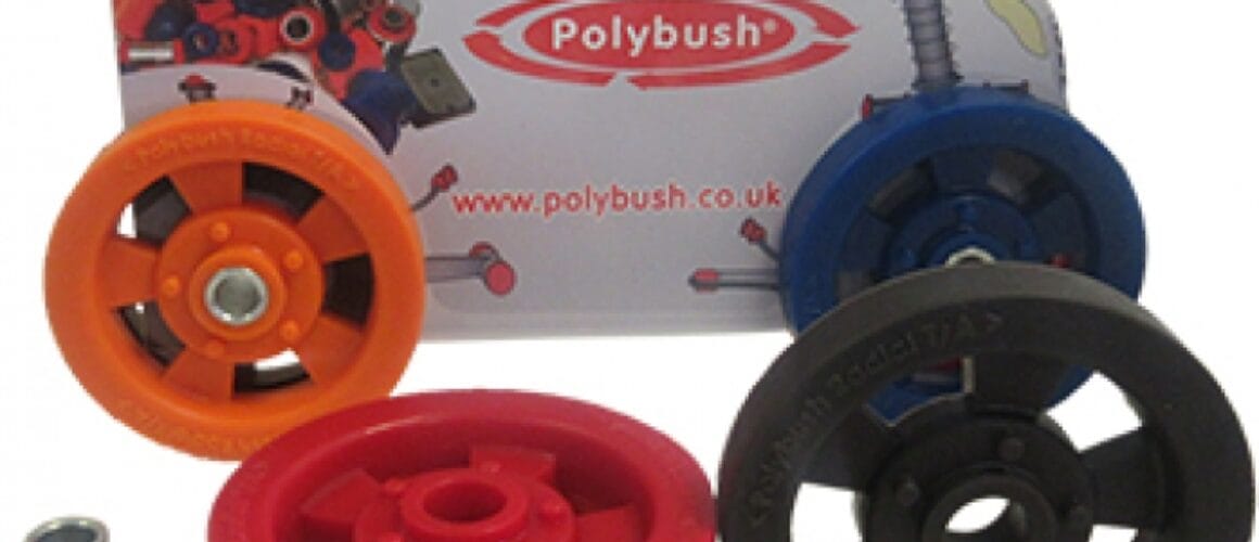 Promotional model car with the polybush logo and website, accompanied by various colourful car suspension bushings and components arranged around it.