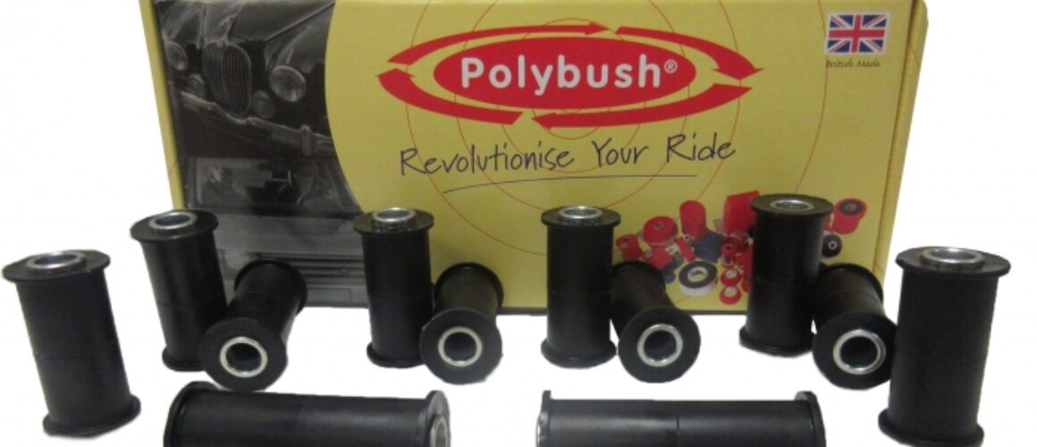 A display of various black polybush brand bushings in front of their product box labelled "revolutionise your ride" with a British flag.