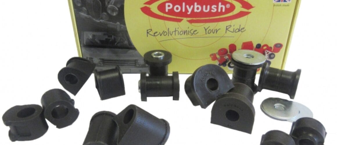 A set of black polybush car suspension parts displayed in front of their packaging box, which features the brand logo and the text "revolutionise your ride.