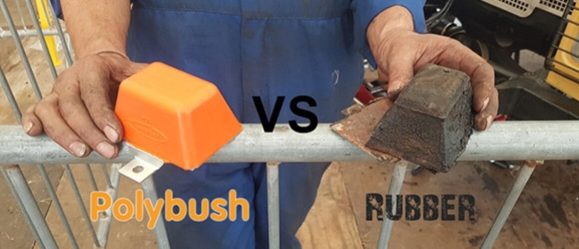 A person in a blue work uniform holds two types of bushings over a metal barrier at a farm; on the left, a new orange polyurethane bushing labelled 'polybush', and on the right, an old, worn rubber bushing labelled 'rubber'.