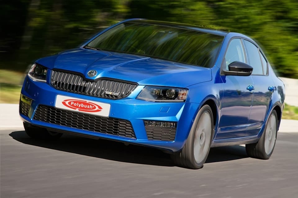 A blue Skoda car travelling on a road, displaying its sleek design and distinct motion blur effect on the wheels, emphasising its speed.