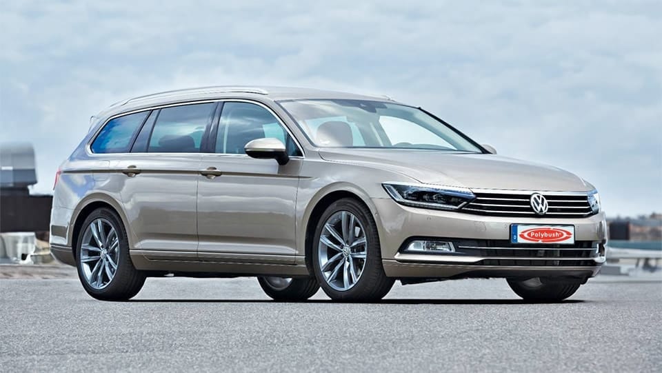 A metallic grey Volkswagen Passat estate parked on a tarmac road with a cloudy sky in the background.