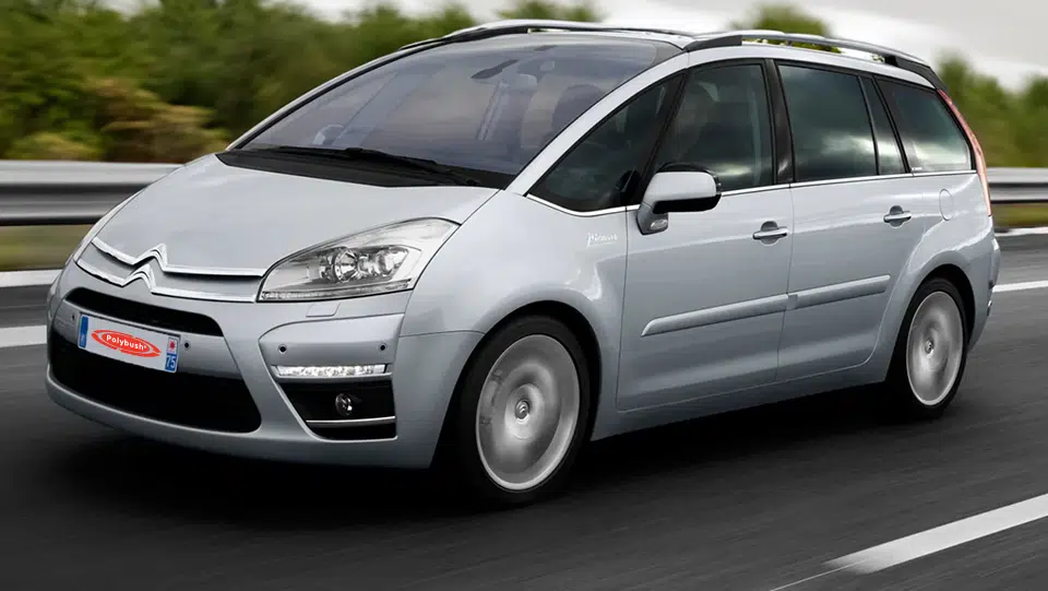 A silver citroën picasso people carrier on a motorway, displaying motion blur on the road to suggest speed, under a cloudy sky.