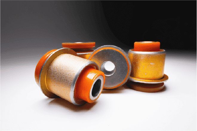 Four old film canisters with orange and yellow lids, some tipped over, against a white to grey gradient backdrop.