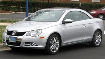 A silver Volkswagen Eos coupé parked on a suburban street during the day.